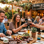 Outdoor restaurant patio with guests enjoying grilled chicken skewers, sliced steak, sausages, and shared meat platters during spring patio dining service.